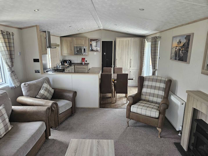 Inside of the lodge showing open plan kitchen, dining and living area.